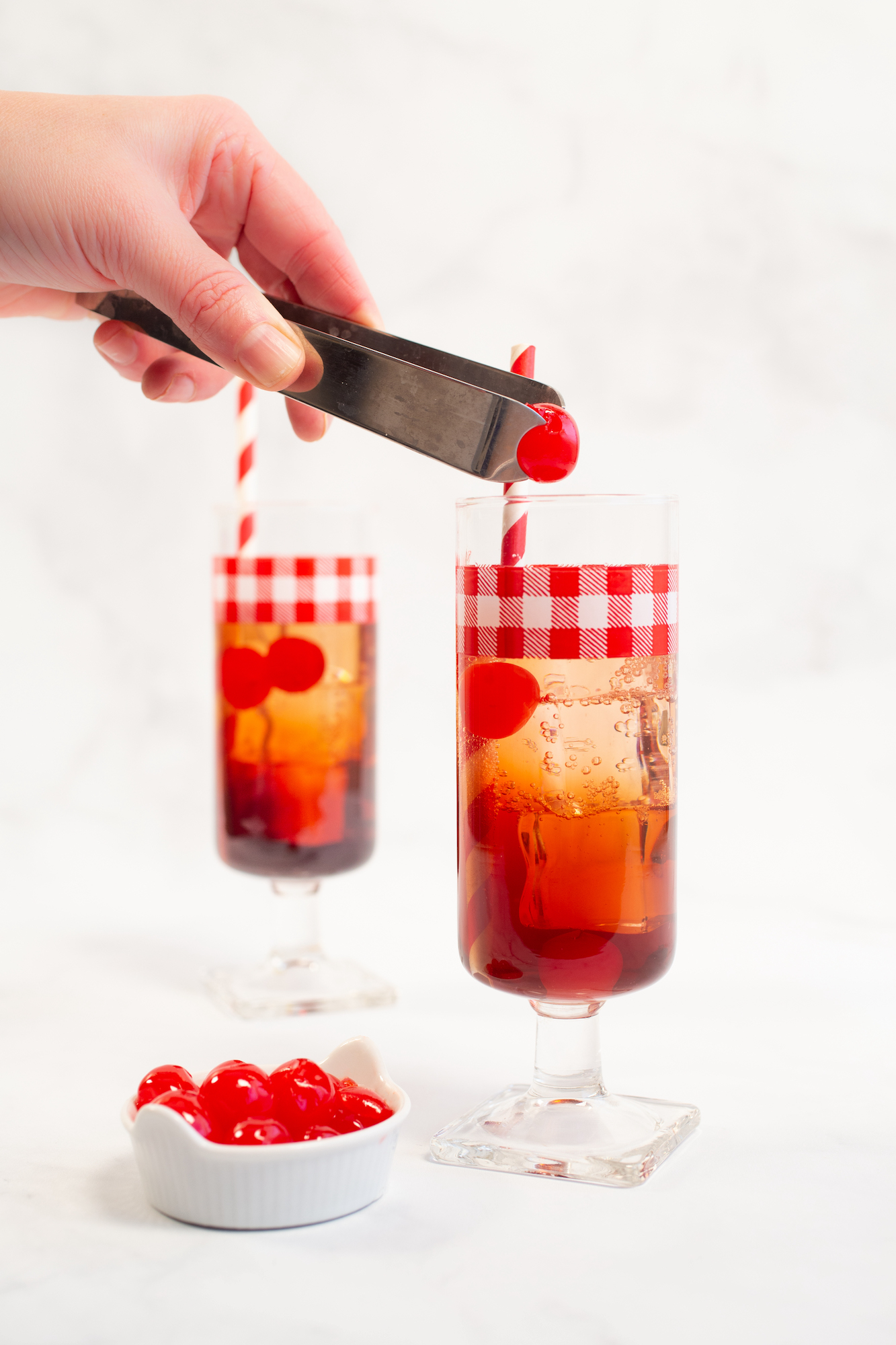 placing a cherry in a Dirty Shirley cocktail