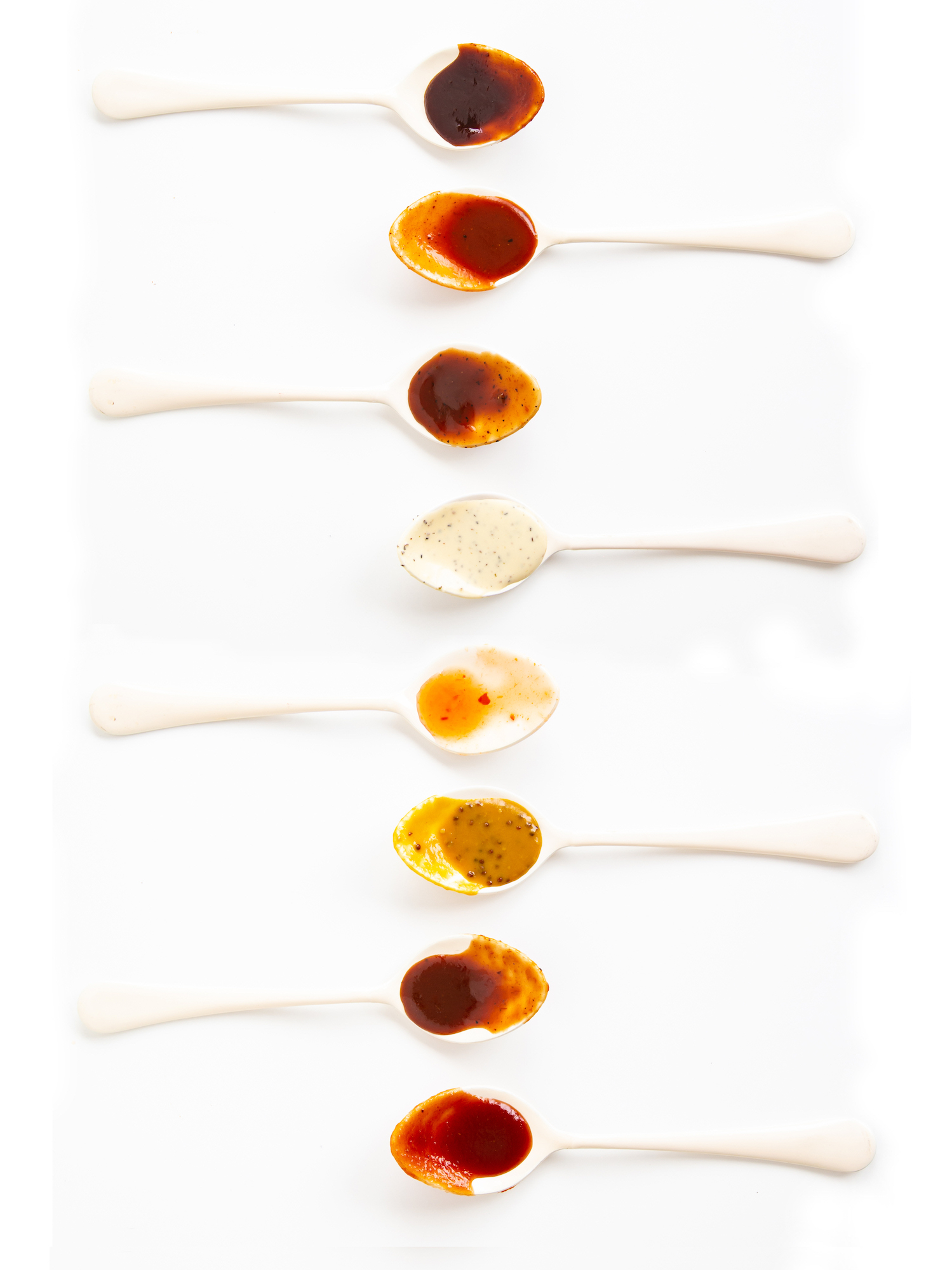 BBQ sauces on spoons
