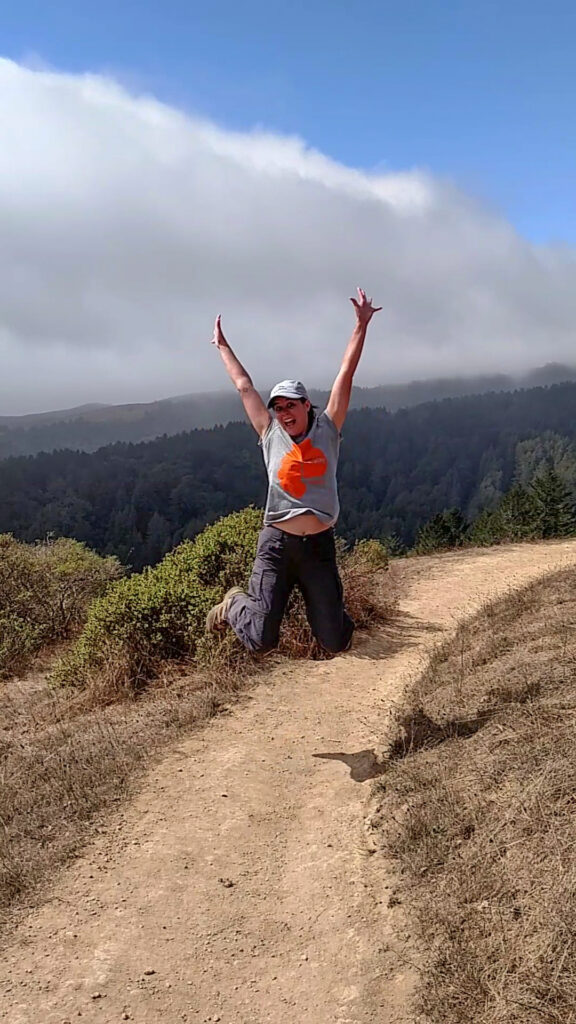 jumping in the air along a California hiking trail