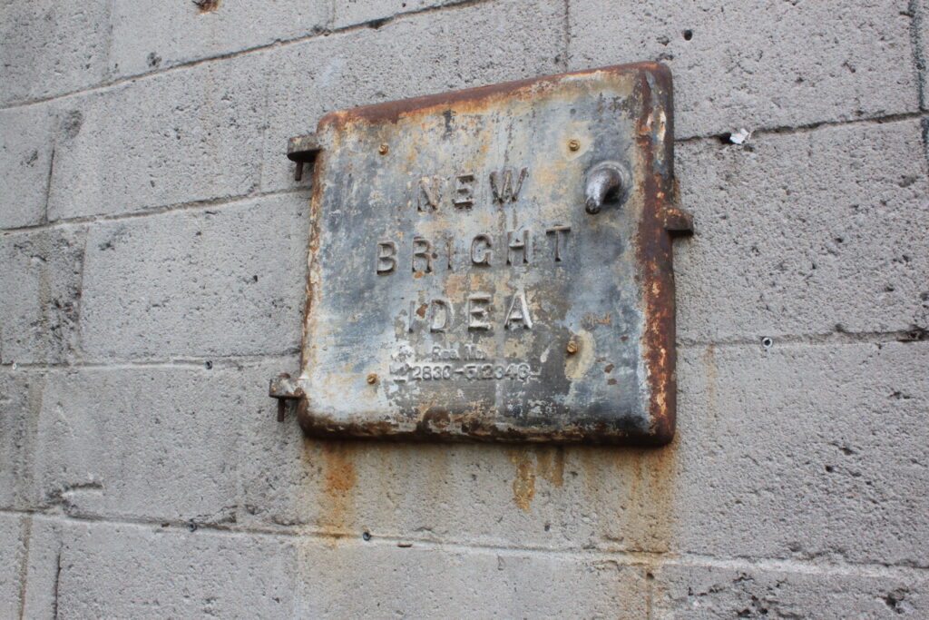 rusty door reading "new bright idea"