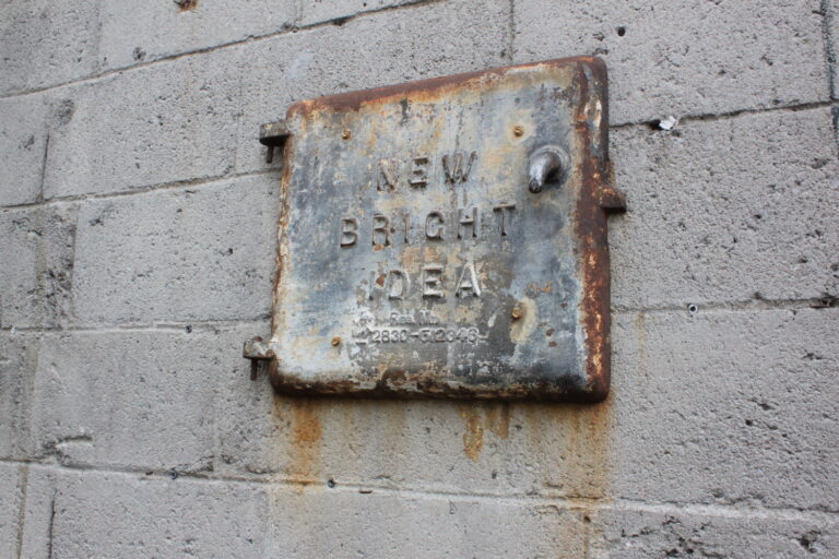 rusty door reading "new bright idea"