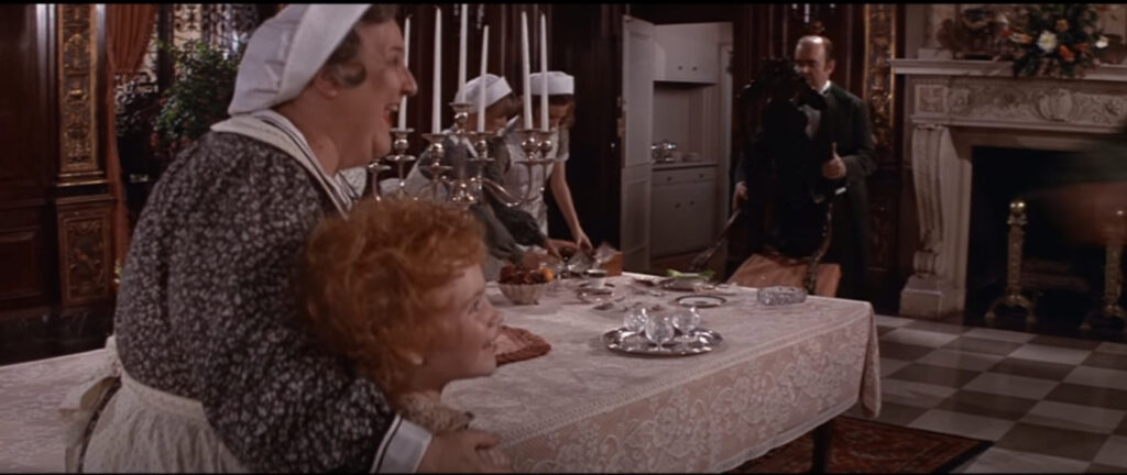 screenshot from the film Annie - servants in a dining room