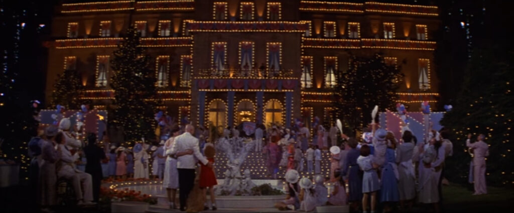 screenshot from the film Annie - Warbucks Mansion at the finale decorated with lights for a party