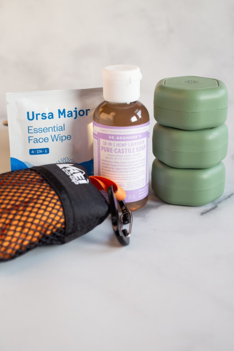 travel toiletry items: microfiber towel, face wipes, Castile soap, stackable toiletry containers