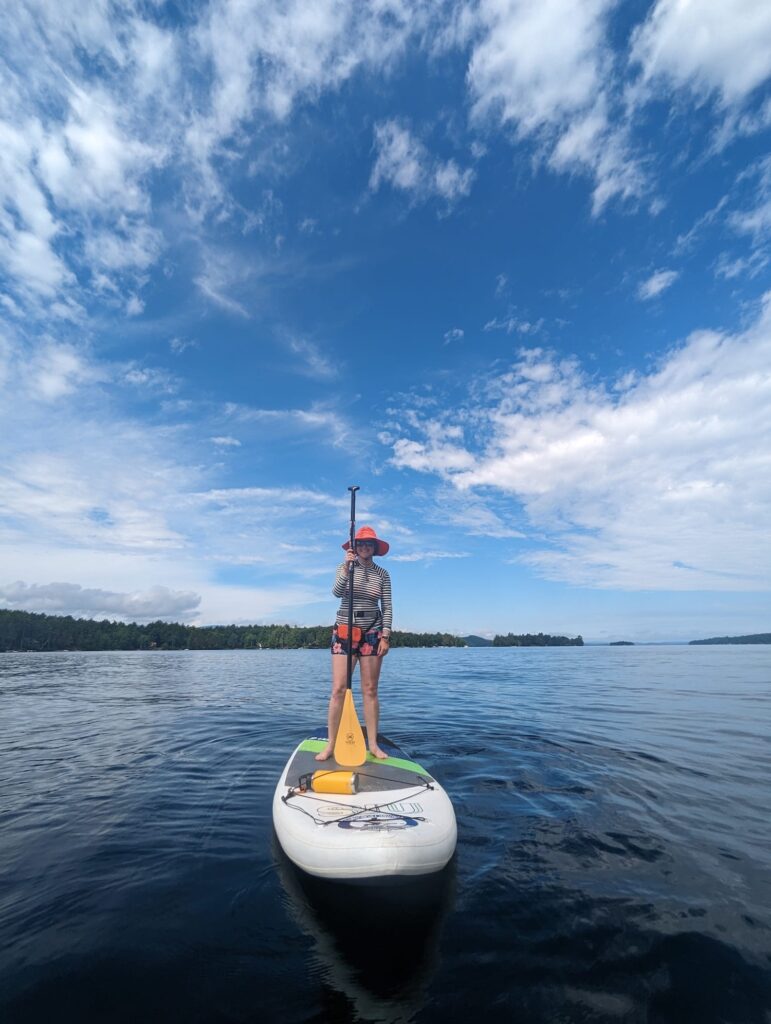 paddle boarding on a lake with blue sky