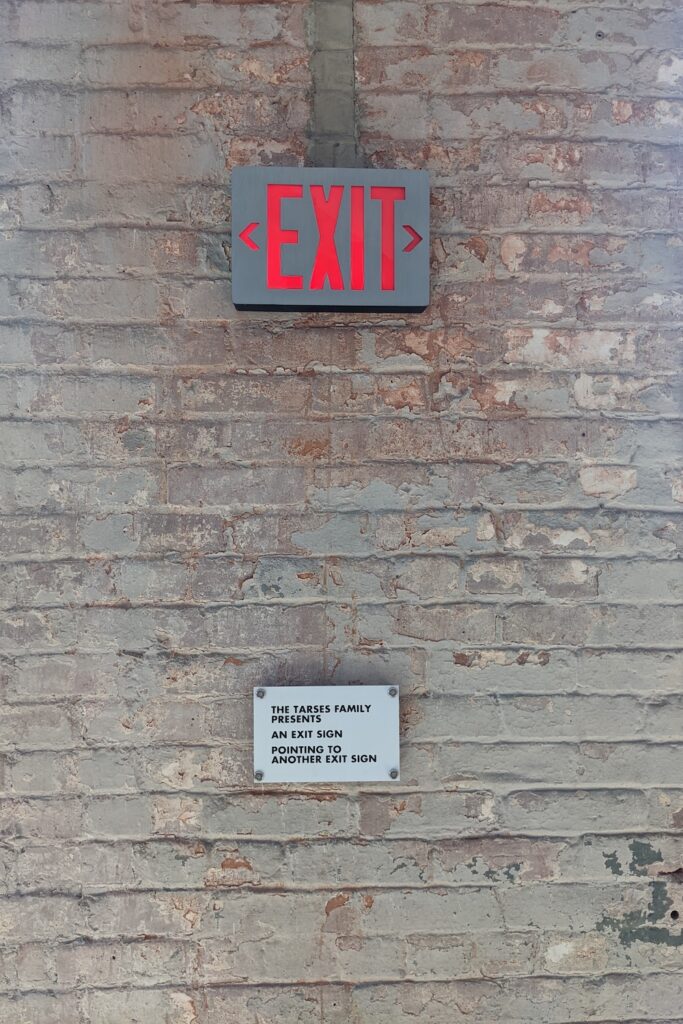 exit sign on a brick wall