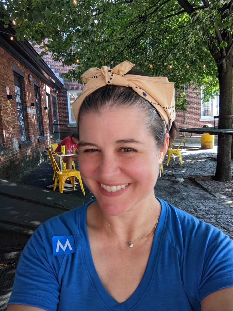 person wearing a bandana and a blue v-neck t-shirt