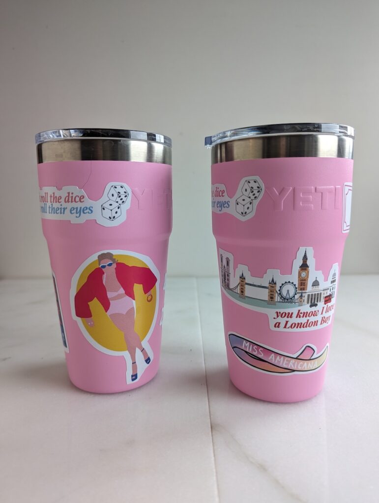 two pink Yeti tumblers with Taylor Swift stickers