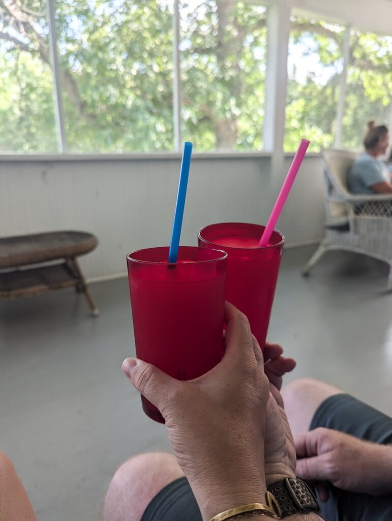 toasting with pink slushy drinks in red cups