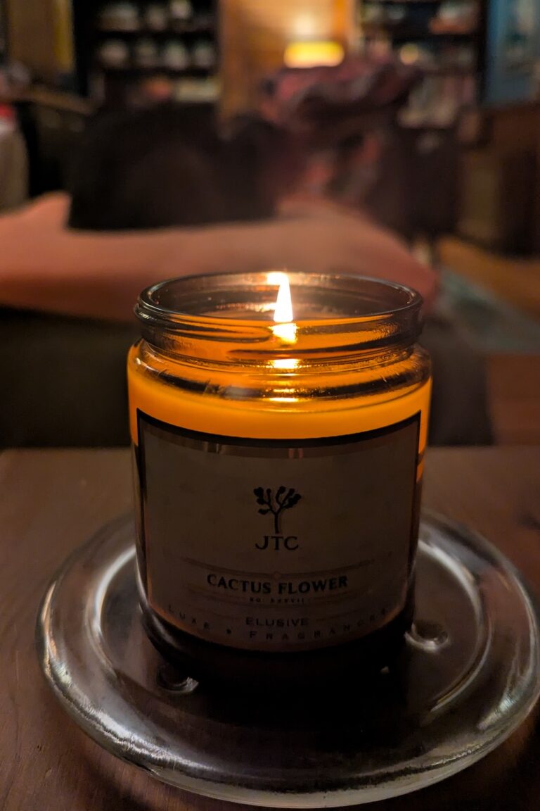 candle burning on a clear glass dish
