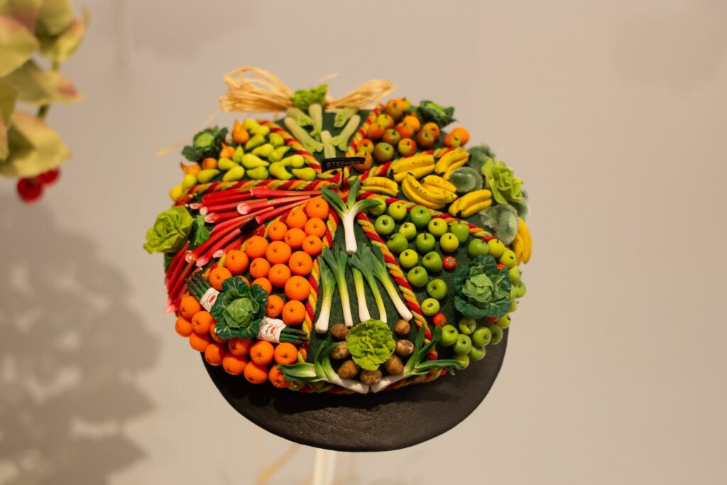hat covered in tiny fake produce