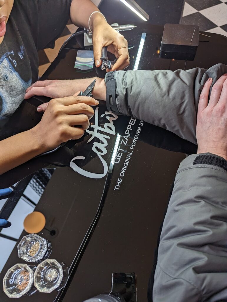 getting a bracelet permanently zapped on at Catbird