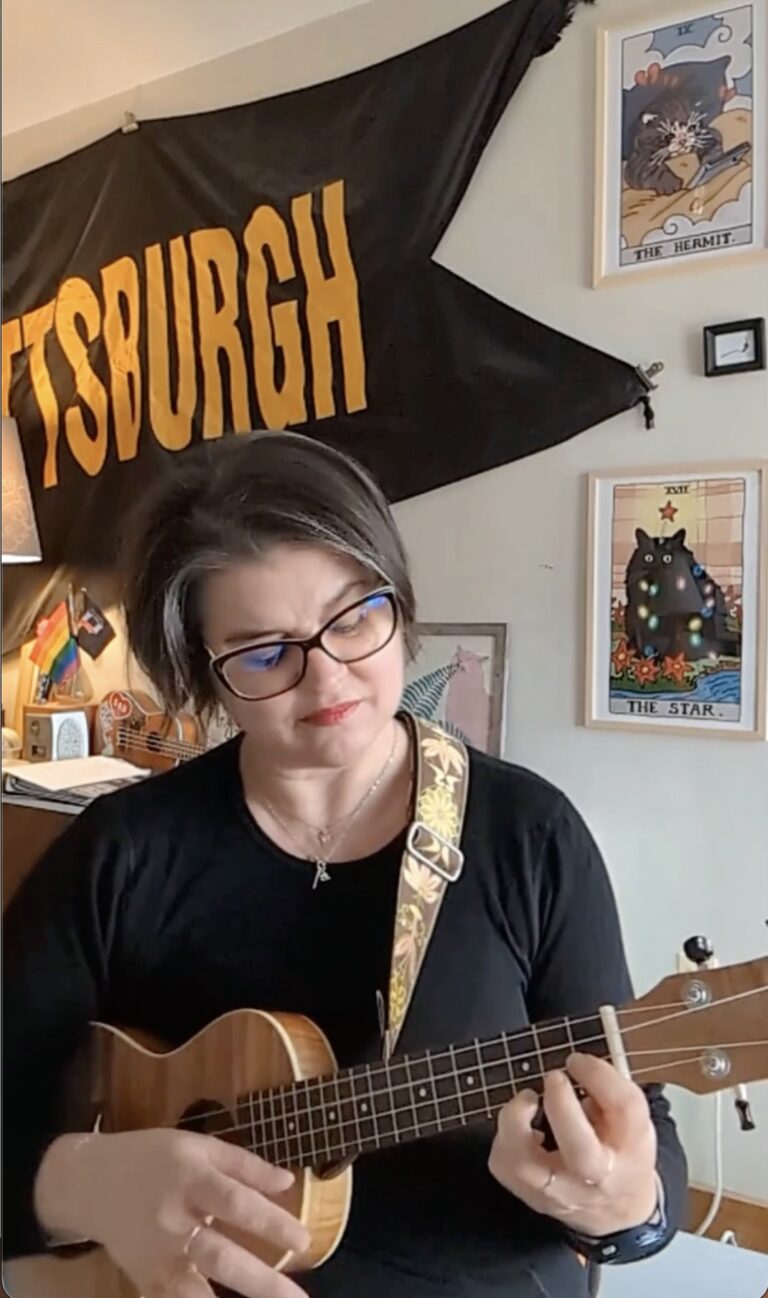 woman playing ukulele