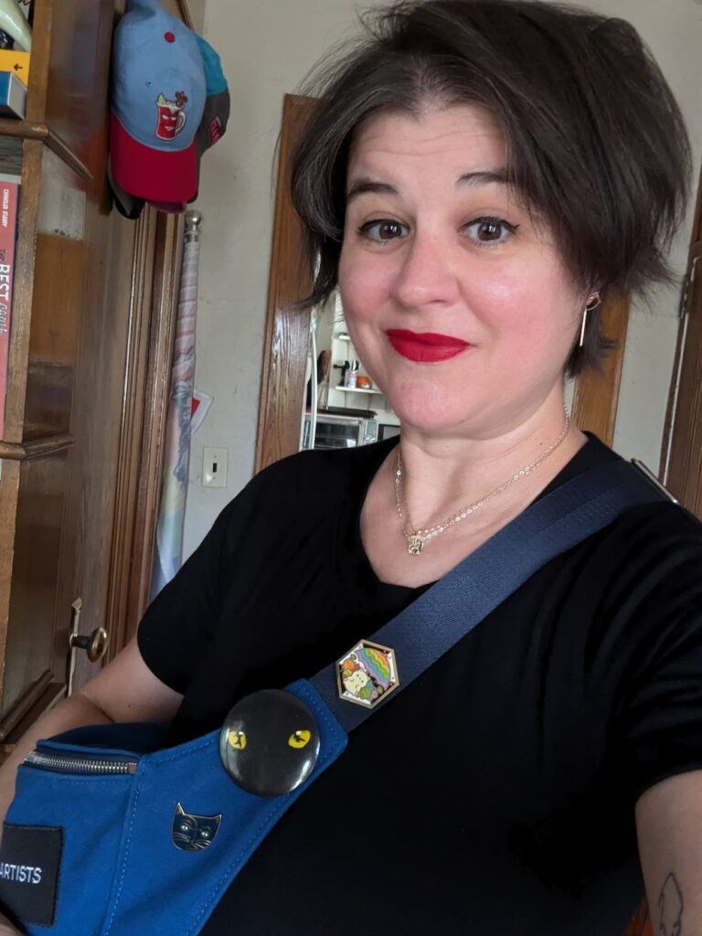 woman wearing CATS musical pins