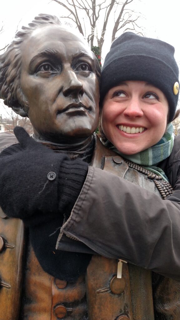 woman embracing a statue of Alexander Hamilton